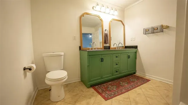 a bathroom with a sink mirror vanity and toilet