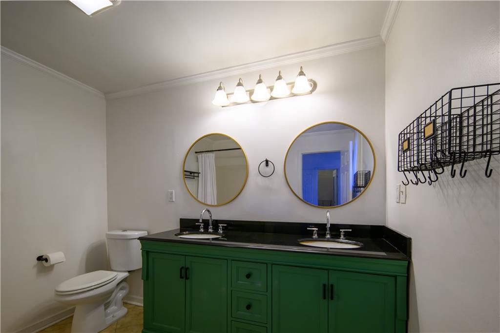 2881 Parrott Avenue Northwest Atlanta, GA 30318 - Photo 19 of 32 a bathroom with a toilet sink and mirror
