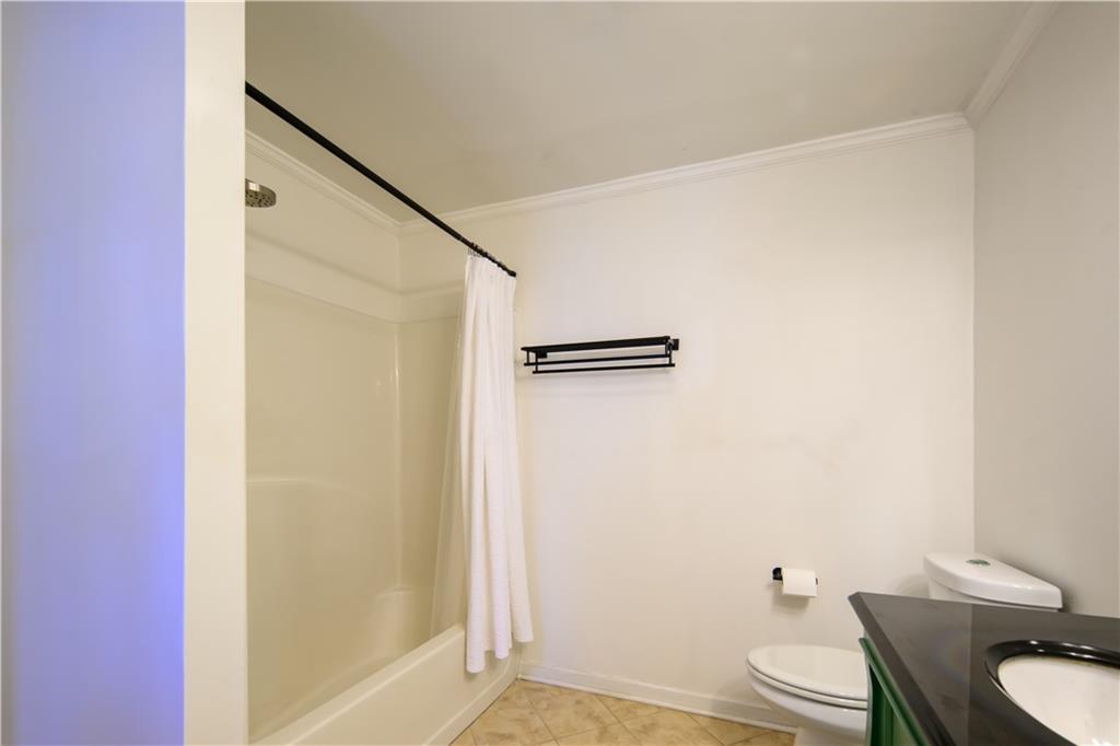 2881 Parrott Avenue Northwest Atlanta, GA 30318 - Photo 20 of 32 a white toilet sitting next to a bathroom sink