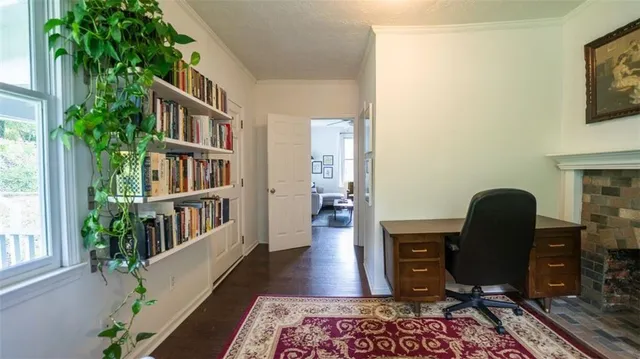 a view of a workspace with furniture and a potted plant