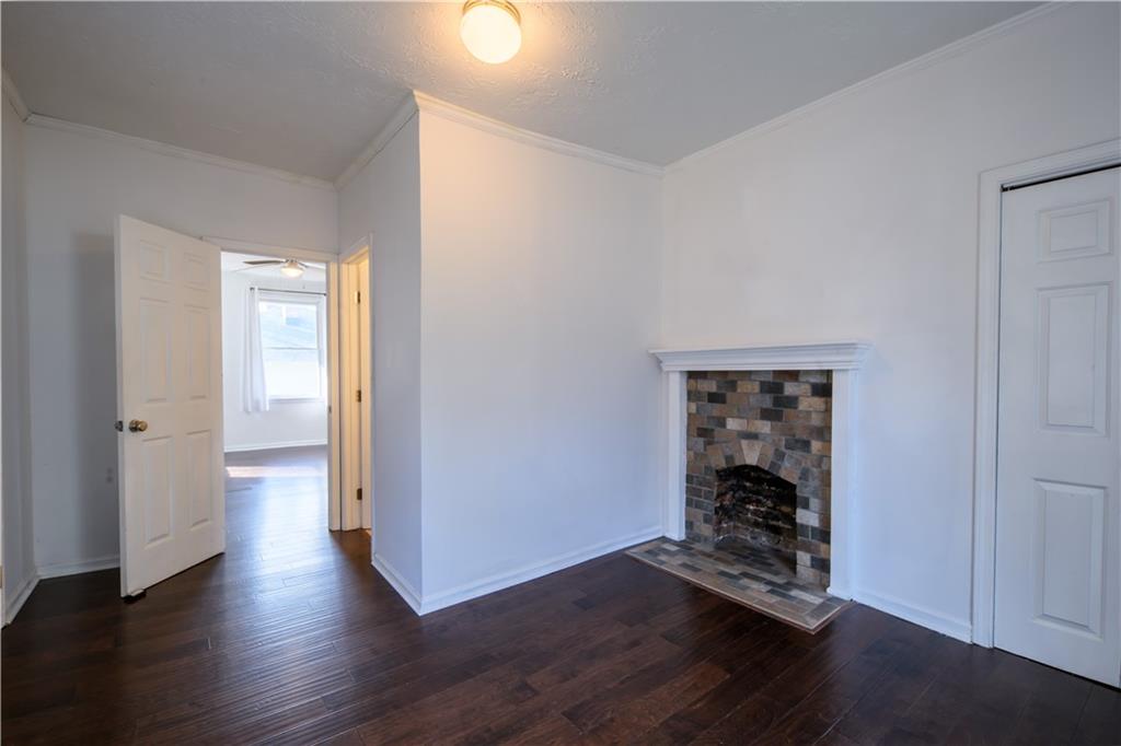 2881 Parrott Avenue Northwest Atlanta, GA 30318 - Photo 22 of 32 an empty room with wooden floor closet and windows