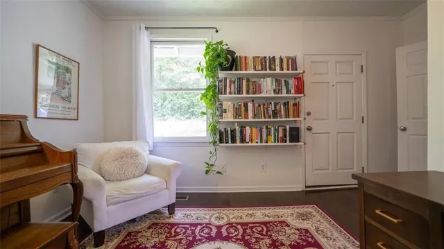 a living room with furniture and a book shelf