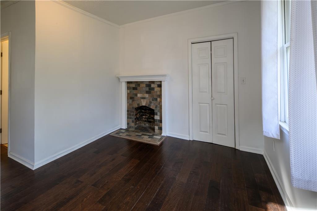 2881 Parrott Avenue Northwest Atlanta, GA 30318 - Photo 23 of 32 an empty room with wooden floor closet and windows