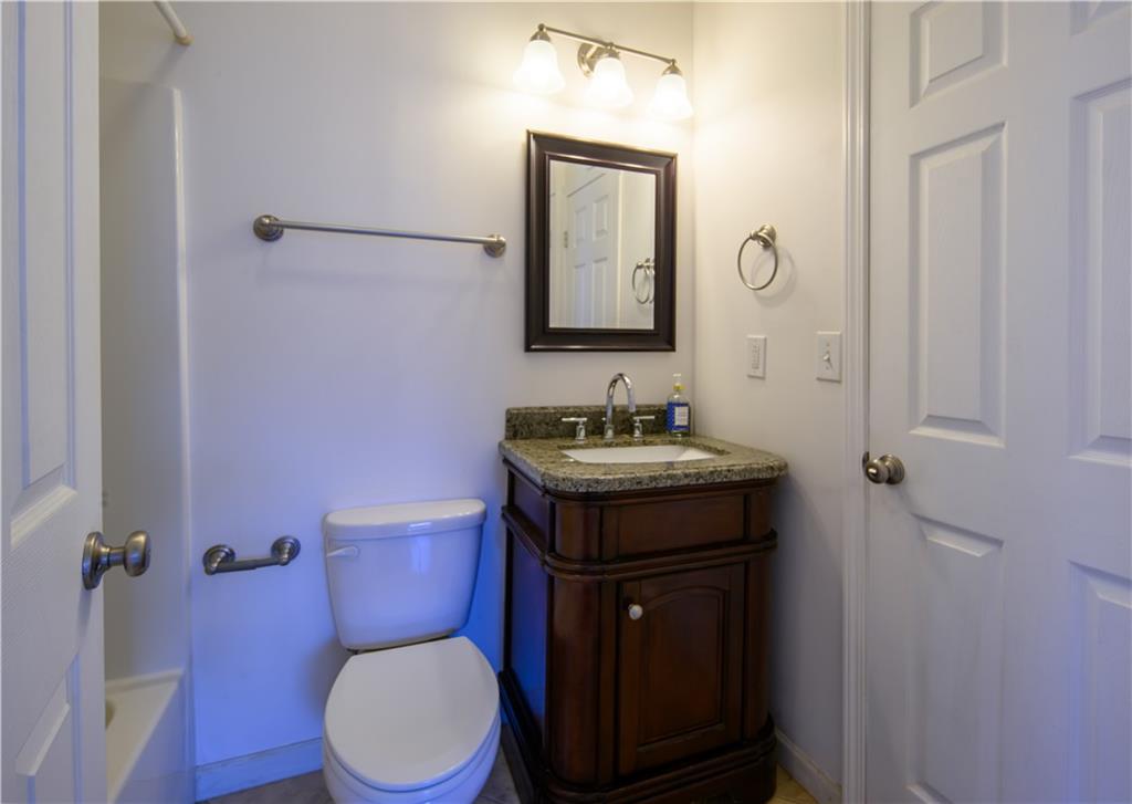 2881 Parrott Avenue Northwest Atlanta, GA 30318 - Photo 25 of 32 a bathroom with a granite countertop toilet sink and mirror