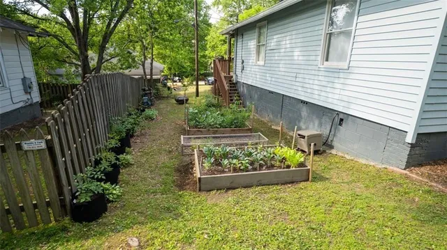 a view of a backyard with wooden fence