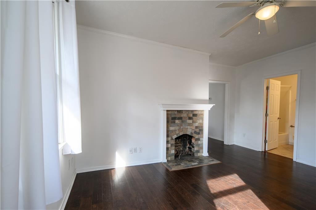 2881 Parrott Avenue Northwest Atlanta, GA 30318 - Photo 5 of 32 a view of an empty room with wooden floor and a window