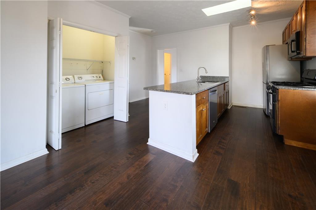 2881 Parrott Avenue Northwest Atlanta, GA 30318 - Photo 8 of 32 a kitchen with sink cabinets and wooden floor