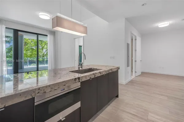 a kitchen with a sink and a large window