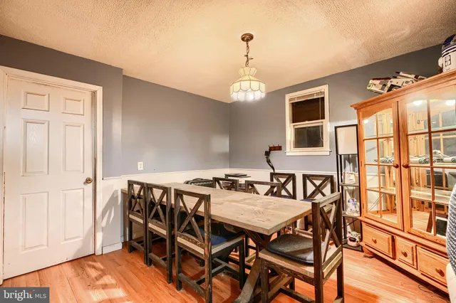 a view of a dining room with furniture wooden floor and chandelier