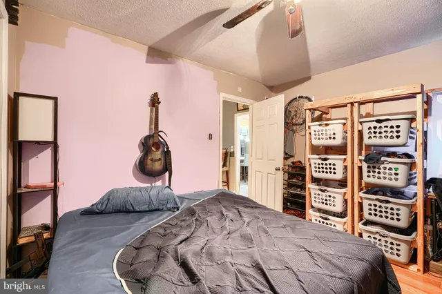 a bedroom with a bed a dresser and book shelf