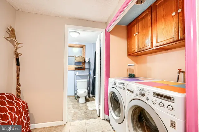 a view of storage and utility room with washer and dryer