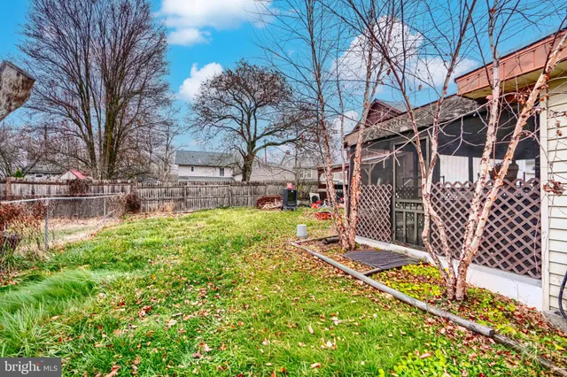 a view of backyard with wooden fence