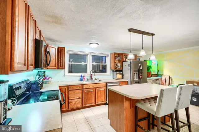 a kitchen with a table chairs sink and cabinets