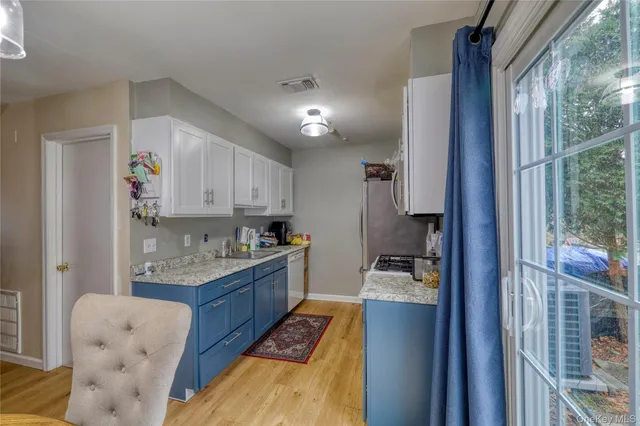 a kitchen with granite countertop cabinets and stainless steel appliances