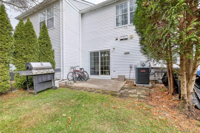 a backyard of a house with table and chairs