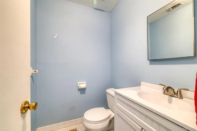 a bathroom with a sink a toilet and a mirror