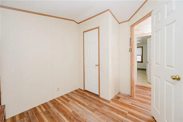 a view of a room with wooden floor and bathroom