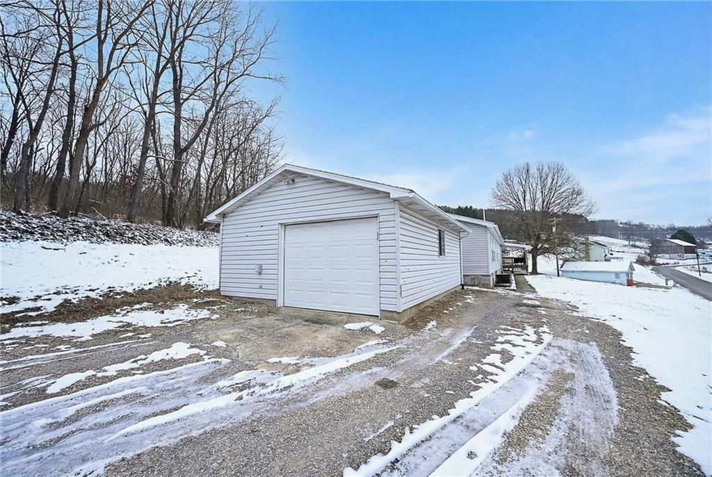 42 Gress Road Creekside, PA 15732 - Photo 32 of 41 a view of a house with a yard covered with snow in the background