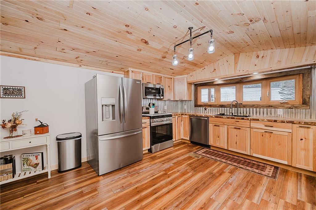 42 Gress Road Creekside, PA 15732 - Photo 9 of 41 a kitchen with granite countertop stainless steel appliances a refrigerator cabinets and wooden floor