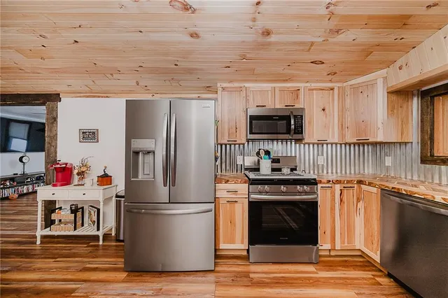 a kitchen with stainless steel appliances granite countertop a stove and a refrigerator