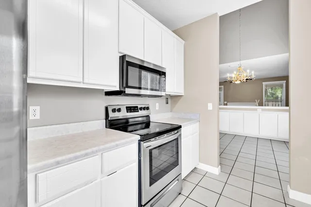 a kitchen with a sink cabinets and window