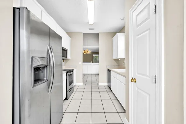a kitchen with granite countertop a stove sink and cabinets