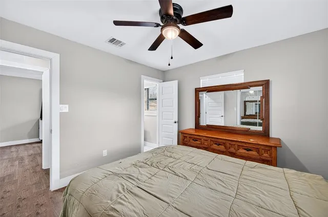 a bedroom with a bed and a large mirror