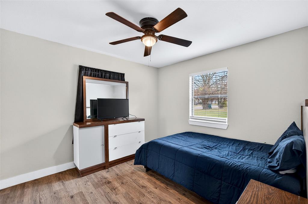 604 East Summit Street Sherman, TX 75090 - Photo 19 of 30 a living room with a bed furniture and a flat screen tv