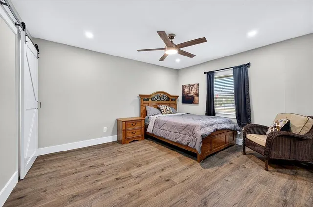 a bedroom with a bed couch and window