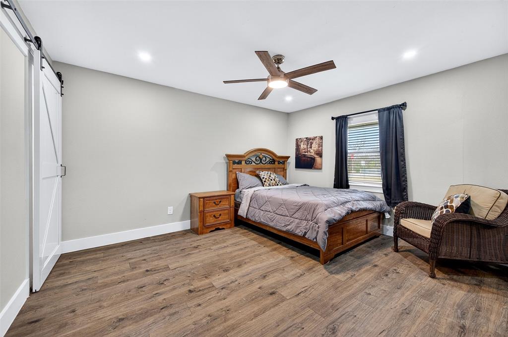 604 East Summit Street Sherman, TX 75090 - Photo 21 of 30 a bedroom with a bed couch and window