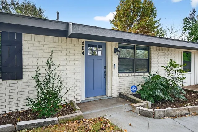 a couple of potted plants in front of door