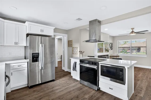 a kitchen with a stove sink and refrigerator