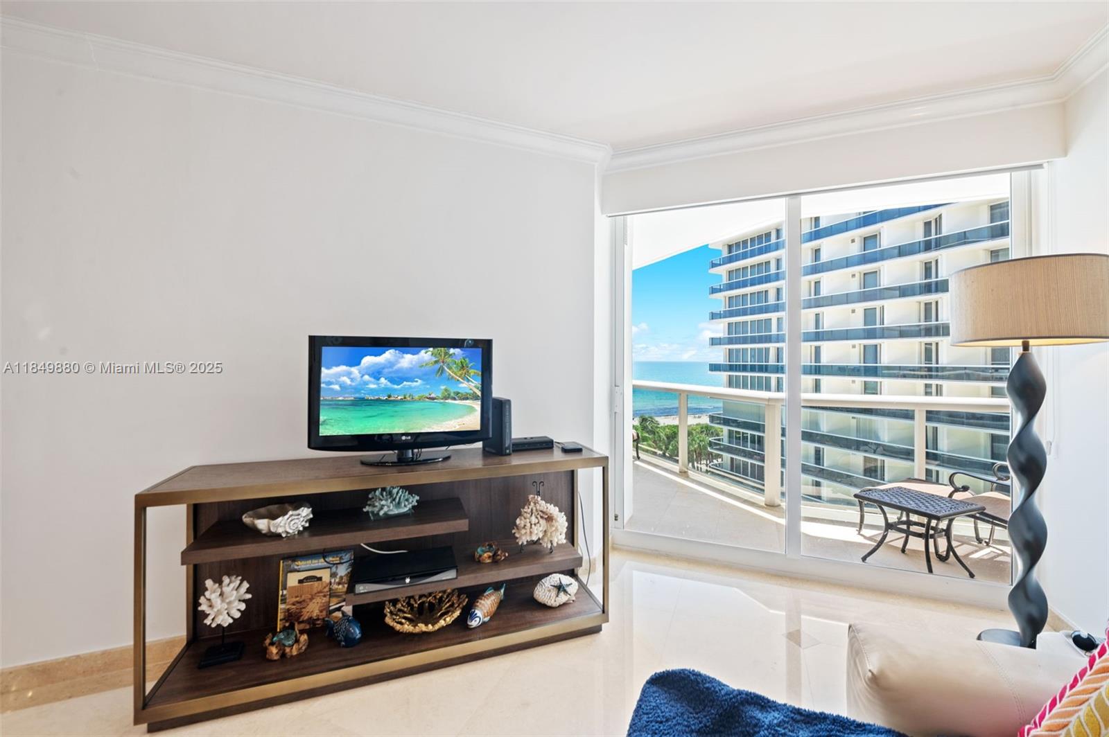 9595 Collins Avenue, Unit N7D Surfside, FL 33154 - Photo 12 of 32 a room with furniture and a flat screen tv