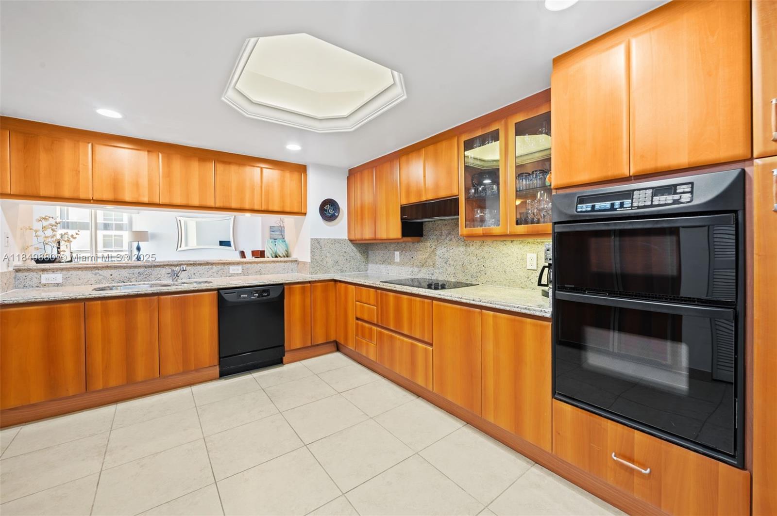 9595 Collins Avenue, Unit N7D Surfside, FL 33154 - Photo 16 of 32 a kitchen with stainless steel appliances granite countertop a sink and cabinets