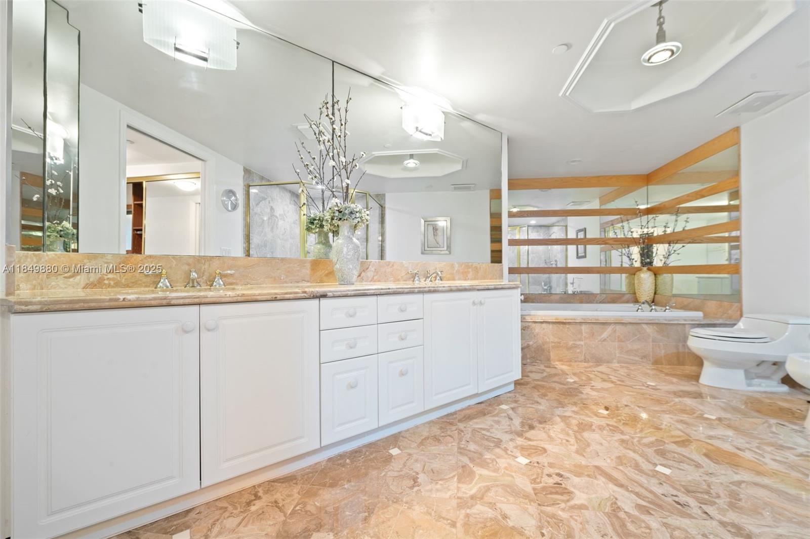 9595 Collins Avenue, Unit N7D Surfside, FL 33154 - Photo 23 of 32 a bathroom with a sink a vanity and a large mirror