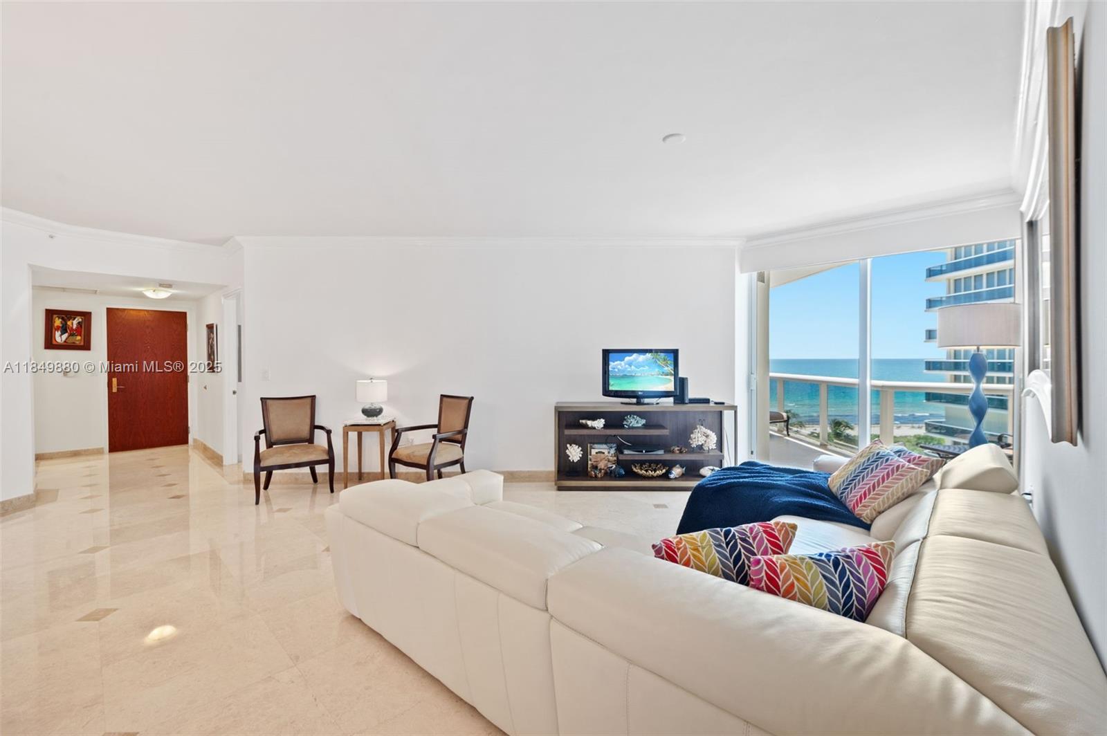 9595 Collins Avenue, Unit N7D Surfside, FL 33154 - Photo 10 of 32 a living room with furniture and a flat screen tv
