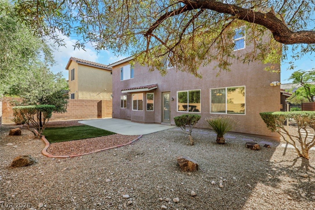 10328 Hawk Ravine Street Las Vegas, NV 89178 - Photo 46 of 55 A desert oasis backyard provides a refreshing blend of artificial turf and gravel landscaping for minimal upkeep.