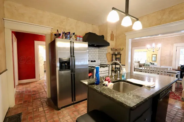 a kitchen with counter top space and sink