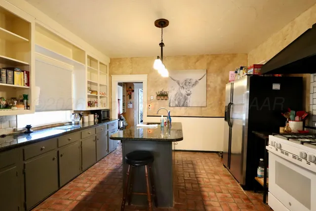a dining table with a sink and cabinets