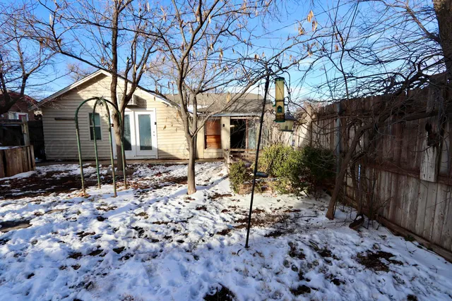 a view of a house with wooden chairs