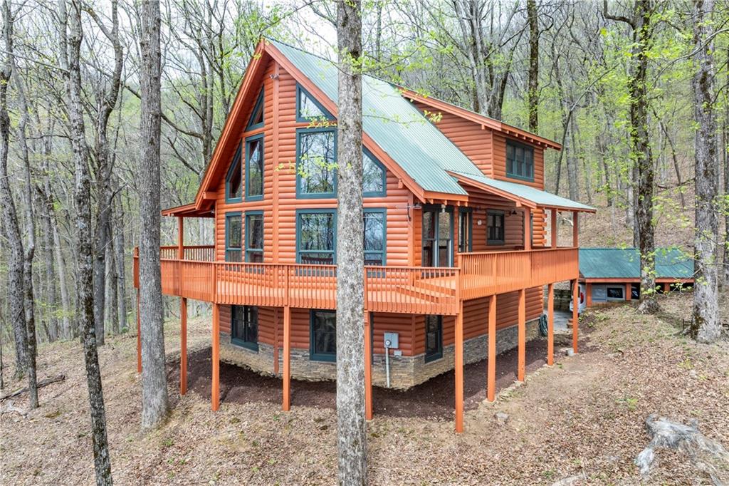 453 Sunset Cliff Drive Jasper, GA 30143 - Photo 1 of 1 a backyard of a house with table and chairs