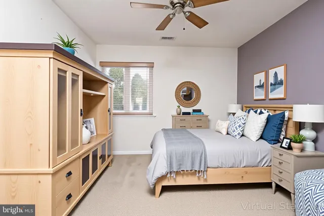 a bedroom with a bed couch and window