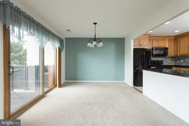 a view of a kitchen with a sink and cabinets