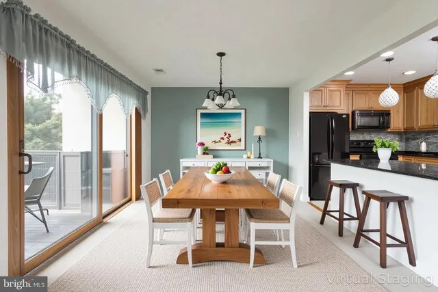 a dining room with furniture window and wooden floor