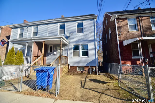 a front view of a house with barbeque