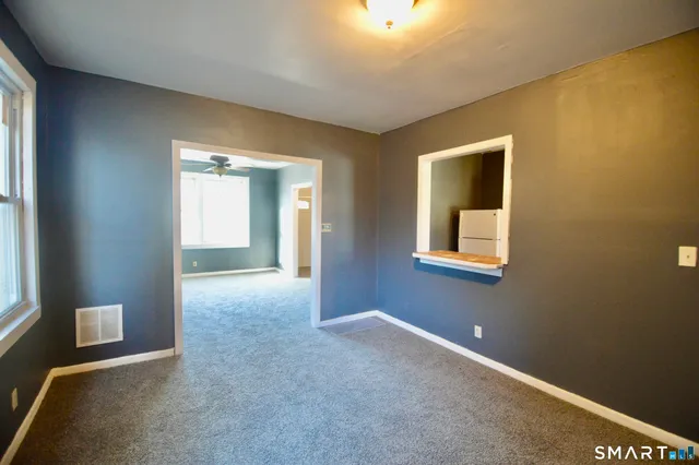 an empty room with windows and closet