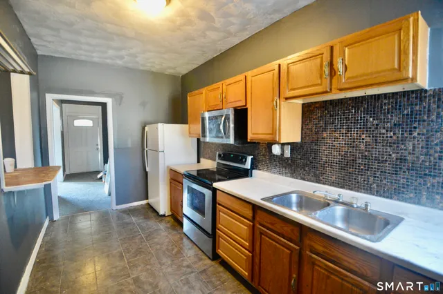a kitchen that has a sink and a stove