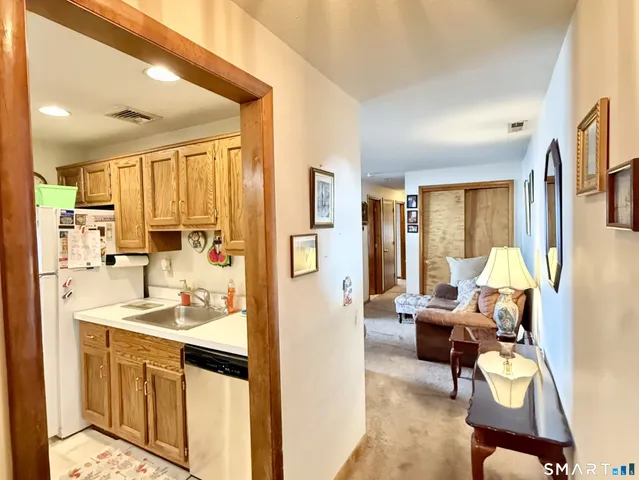 a view of living room filled with furniture and large window