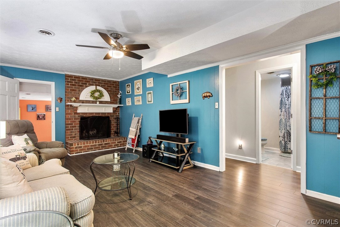 12808 Middlebrook Road Chester, VA 23831 - Photo 17 of 35 a living room with furniture a fireplace and a flat screen tv