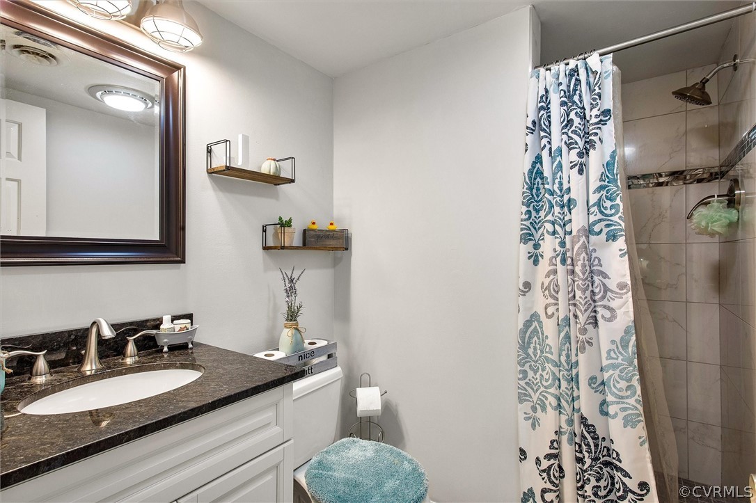 12808 Middlebrook Road Chester, VA 23831 - Photo 24 of 35 a bathroom with a granite countertop sink and a mirror